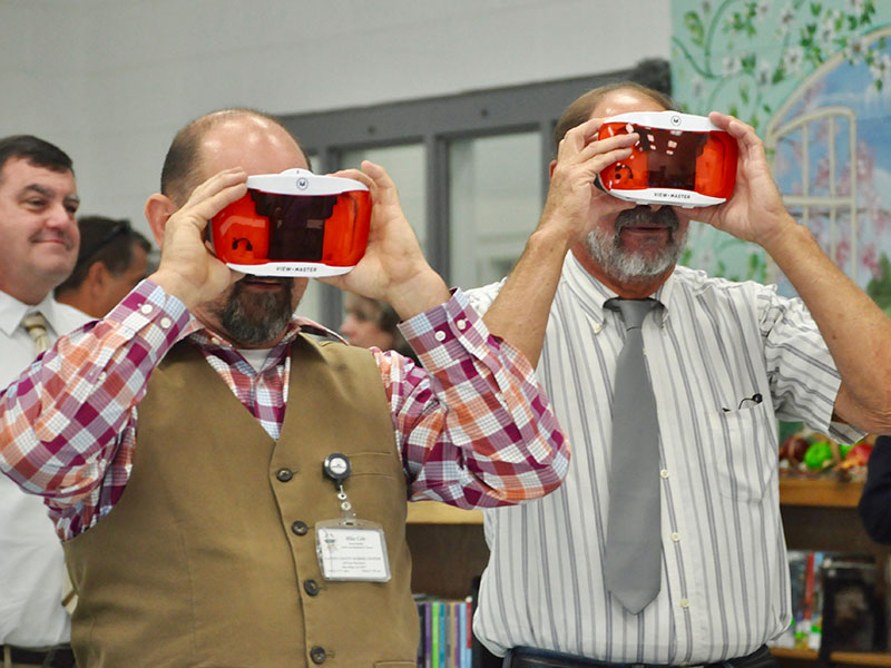 Fannin County Board of Education members Mike Cole, left, and Lewis Deweese try out recently purchased view masters in the Fannin County Middle School media center. FCMS was one of the stops on last week’s school board retreat.
