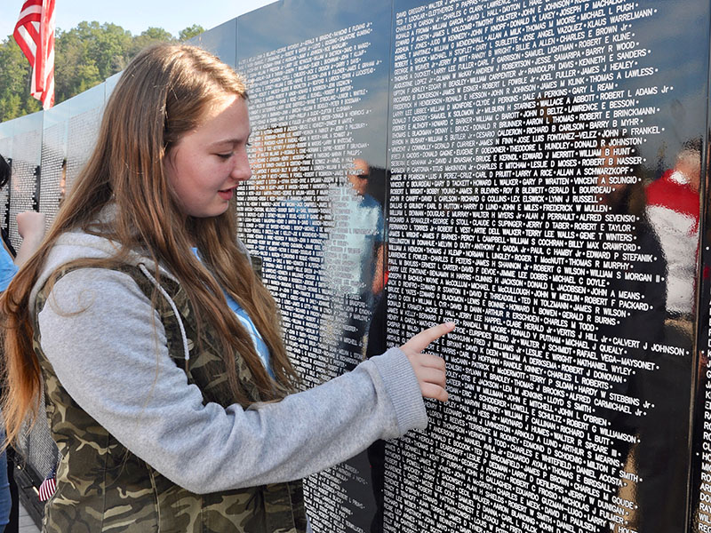 Fannin County Middle School student Haley Thompson visits the The Vietnam Traveling Memorial Wall with her fellow classmates during its residency in Blue Ridge.