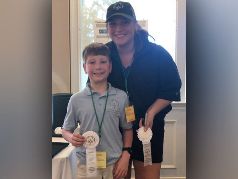 Alex Hughes was the youngest Special Olympics athlete to compete with the unified golfers at the State Games in Valdosta, Georgia, Saturday October 12. Hughes and unififed partner Ivie Chapman smile for a photo with their fourth place ribbon.