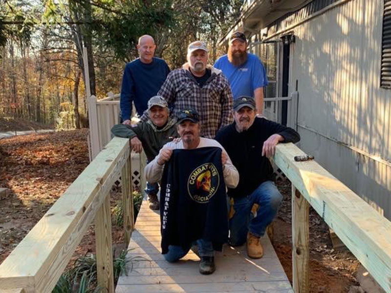 Members of the Combat Veterans Motorcycle Association worked to build a much needed wheelchair ramp for fellow veteran Roger Dionne. Shown on the completed ramp are, from left, front, Bob Renneke, Rob Denison and Paul Hogue; back, Steve Continenza, Dionne and Steve Continenza.