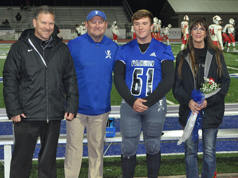 Fannin County High School honored the football seniors before the Rebels game against GAC Friday, November 8. Shown is senior Ethan Mann with head coach Chad Cheatham and mother Susie Mann.
