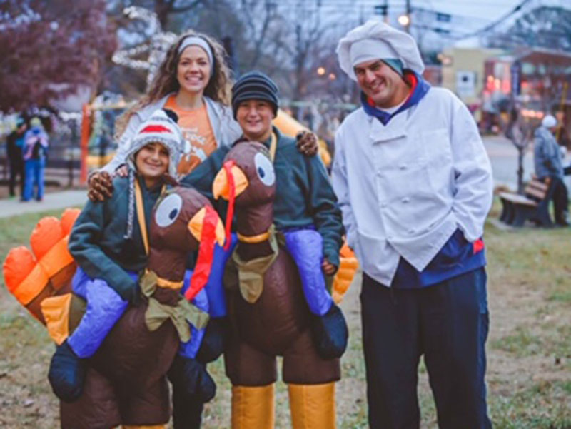10th Annual Blue Ridge Turkey Trot 5K organizer Cherie Wasit stands (back, left) with the previous winner of the event’s Best Dressed contest. Over 700 folks are expected to attend this year’s run scheduled for Thanksgiving morning in downtown Blue Ridge.