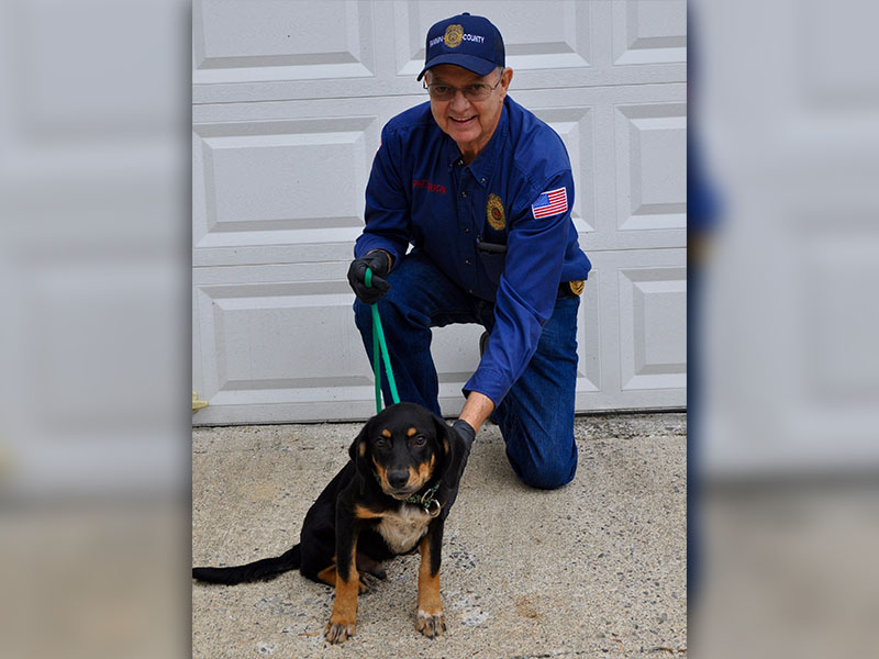 Animal Control Officer Pat Patterson kneels with this male black and tan mixed breed who volunteers have named Clarke. He will be staying at Animal Control until adopted. Clarke boasts a shiny coat and dark brown eyes. View him under Animal Control number 341-19.