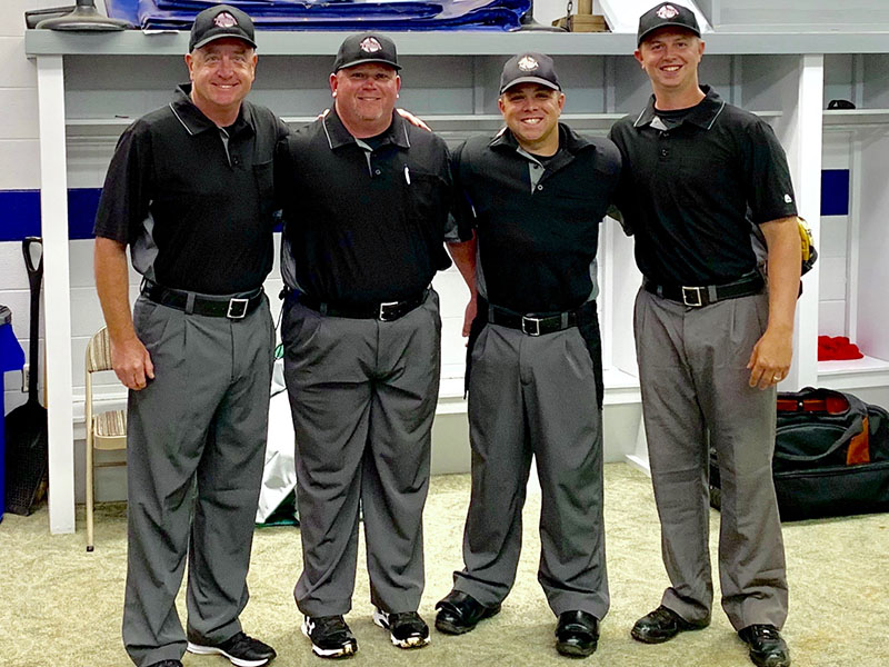 Tim Towe smiles among fellow umpires after working the 2019 Kingsport Regional Final. Shown, from left, are Kerry Bryan, Aaron Hill, Towe and Wes Jones.