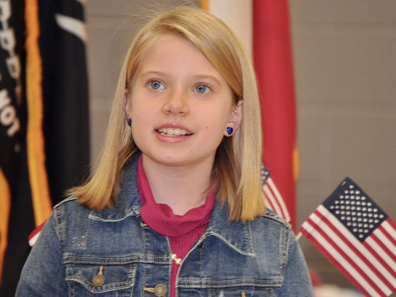 Blue Ridge Elementary School student Laurel Minear sang the first verse of “God Bless the USA” at the school’s Veterans Day Ceremony Friday, November 8.