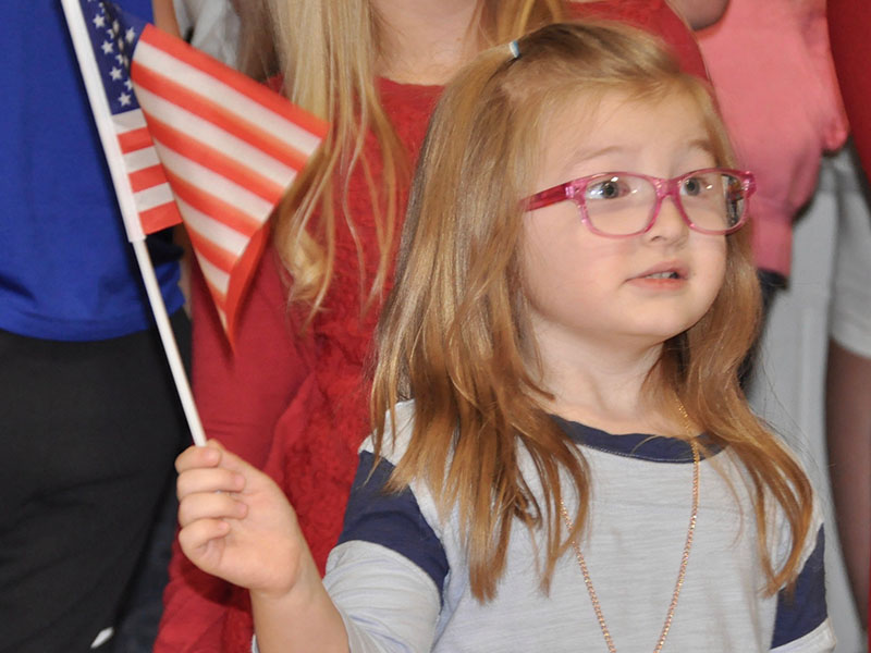 East Fannin Elementary School student Clara Stites excitedly waved the American Flag during the school’s veterans program.