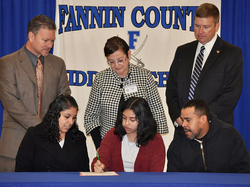 Fannin County Middle School student Estenfania Rosas-Leal signed her REACH scholar contract with her family Tuesday, November 12. Shown are, from left, front, Silvia Espinoza, Rosas-Leal and Ambrosio Rosas; back, Fannin County High School Principal Erik Cioffi, ESOL teacher Alejandra Mills and Superintendent Dr. Michael Gwatney.