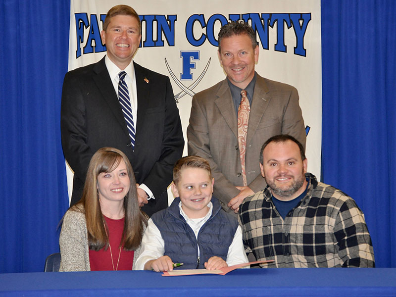 Fannin County Middle School student Silas Campbell signed his REACH scholar contract with his family Tuesday, November 12. Shown are, from left, front, Brooke Campbell, Silas Campbell and Nathan Campbell; back, Superintendent Dr. Michael Gwatney and Fannin County High School Principal Erik Cioffi.