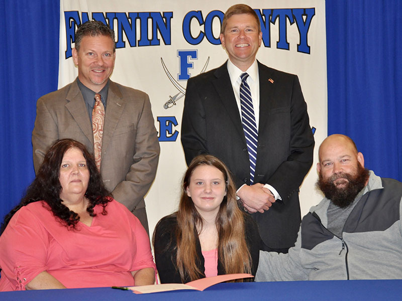 Fannin County Middle School student Alayna Dockery signed her REACH scholar contract with her family Tuesday, November 12. Shown are, from left, front, Heather Dockery, Alayna Dockery and Randy Monkus; back, Fannin County High School Principal Erik Cioffi and Superintendent Dr. Michael Gwatney.