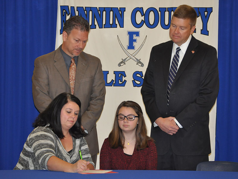 Fannin County Middle School student Emma Pittman signed her REACH scholar contract November 12. Shown are, from left, front, Brandi Pettus and Pittman; back, Fannin County High School Principal Erik Cioffi and Superintendent Dr. Michael Gwatney.
