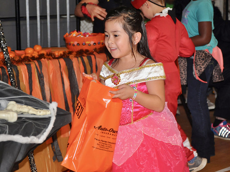 Hannah Carranza-Alvarez excitedly trick-or-treats during West Fannin Elementary School’s event Thursday, October 31.