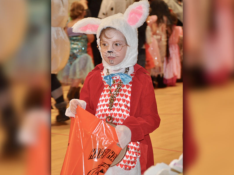 West Fannin Elementary School student River Ensley is disguised as the White Rabbit as she collects candy Halloween Day.