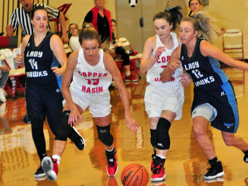 Lady Cougars Riley Smith (15) and Emily Hemming (33) fight for a loose ball in recent action for Copper Basin.