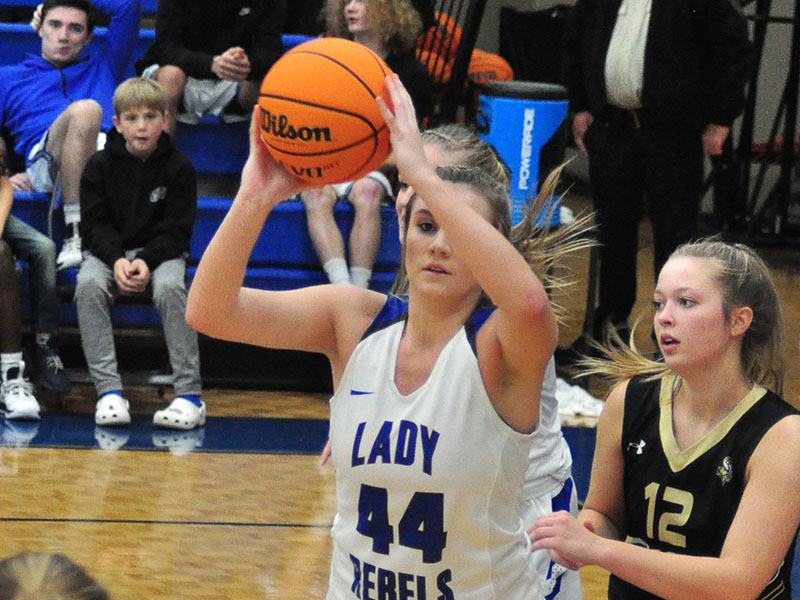 Lady Rebel Olivia Sisson passes the ball out of the paint in recent action for the Lady Rebels basketball team.
