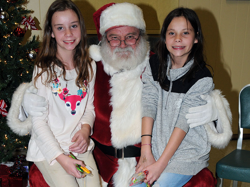 Sisters Alexis, left, and Alicia Green visited with Santa Claus at the Copper Basin Community Center. The event was organized by Polk County Executive Robby Hatcher.  