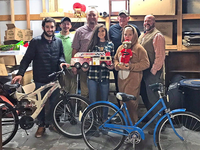 Polk County Executive Robby Hatcher and representatives of C&B Auction and Deli are shown with some of the toys donated for Polk County children. Shown are, from left, Rugby Bunch, Timothy Trulove, Tommy Bunch, Hayley Stephenson, Fred Esch, Macey Bunch and Hatcher.