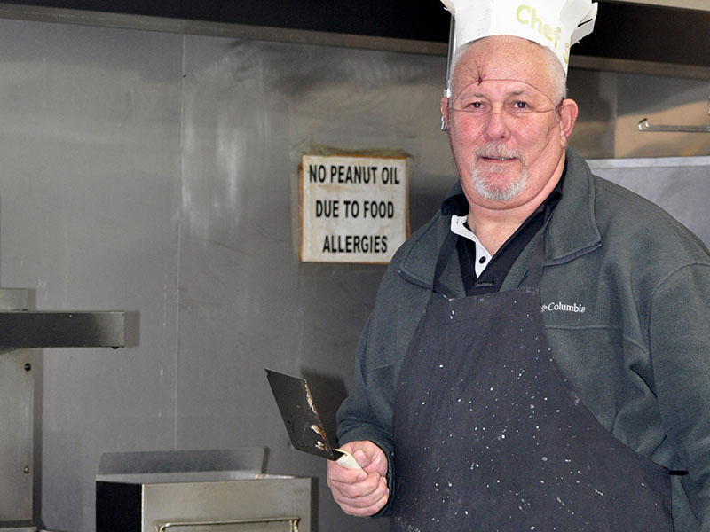 Family man Steve Shamblin dons hairnets and a chef’s hat as he cooks pancakes for hungry folks during a recent fundraiser to raise enough money to pay for the adoption of an orpahaned teenager from Columbia.