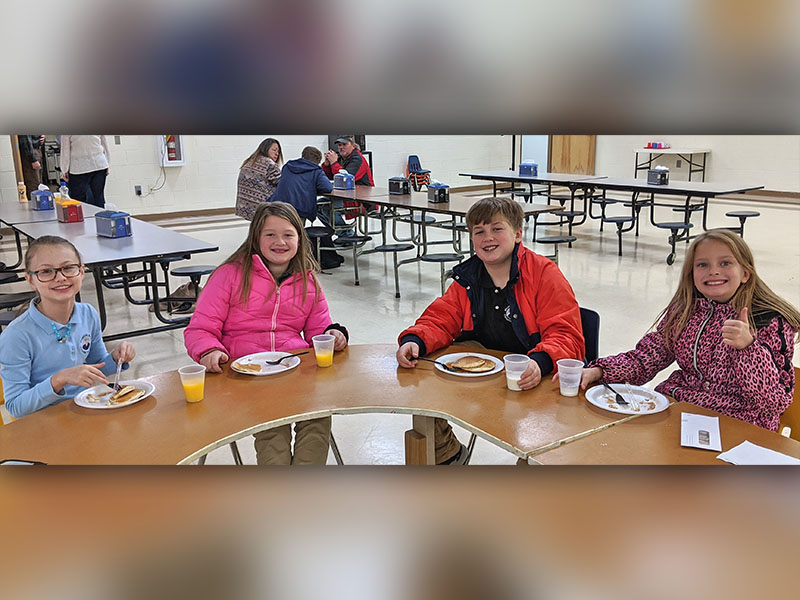 Mountain Area Christian students give a thumbs up to adoption and delicious pancakes during a breakfast fundraiser at the school December 12. School administrators Steve ad Nikki Shamblin are adopting a 14-year-old girl named Elizabeth. She is currently living in an orphanage in Colombia. Shown are, from left, Shelby Roesch, Madilyn Kerley, Elijah Kerley and Elizabeth Nave.