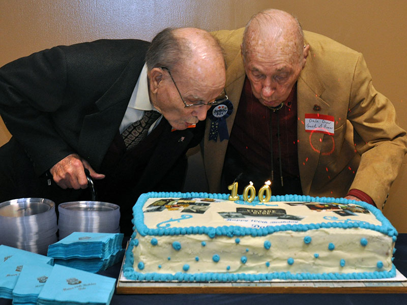 Fannin County historian Dale Dyer, right, blows out his birthday candles with long-time friend and fellow Bomber pilot, James Watkins. Both men are celebrating turning 100-years-old this December.