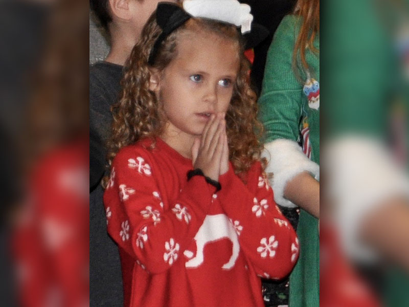Little lamb Hailey Hawkins shows her praying hands while performing the Christmas classic “Go tell it on the Mountain.”