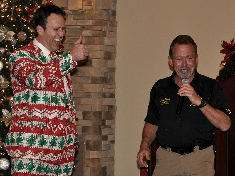 Chief Medical Officer Dr. Dillon Miller laughs with Fire Chief Larry Thomas during the annual EMA Banquet at Willow Creek Falls and Vineyard in Blue Ridge Thursday, December 12.