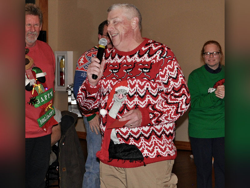 EMA Director Robert Graham insists that someone other than himself be awarded for wearing the “Ugliest” sweater.
