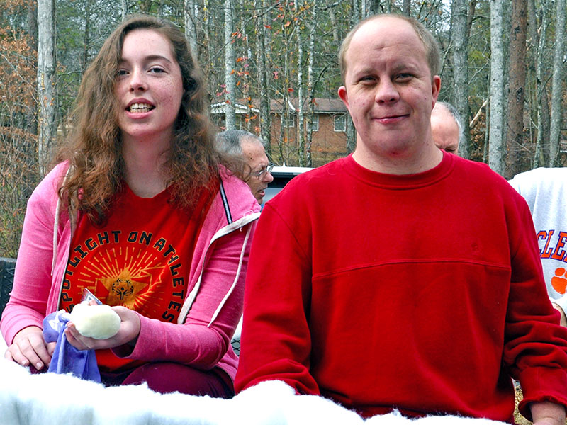 Ansley Price and Jay Jenkins smile while testing out the Fannin County Special Olympics float for the Light Up Blue Ridge Parade.