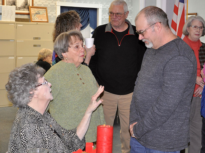 Ducktown Basin Museum Curator Ken Rush, right, talks with Mary Louise Landrum, left, and Peggy Kilpatrick during his going away celebration Tuesday, December 3.