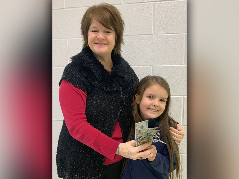 Mountain Area Christian Academy Rozlynne Spry donated $400 to the Patterson family who lost their home in a fire. Spry is shown with Pre-K Director DeGina Scoggins.