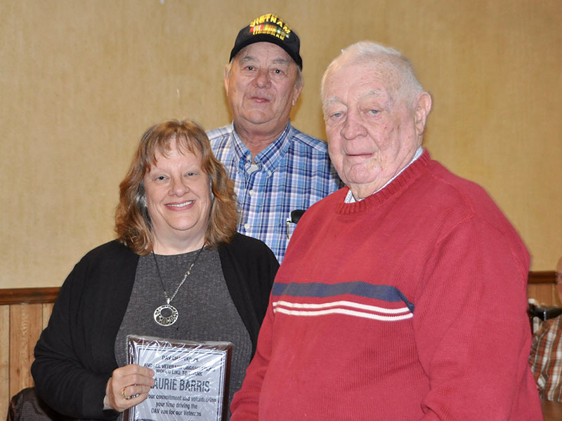 Paul Hunter, middle, and Joe Brandon recognized Laurie Barris at the Fannin County veterans organizations’ Christmas dinner for volunteering to drive community veterans to the VA hospital in the Disabled American Veterans van.