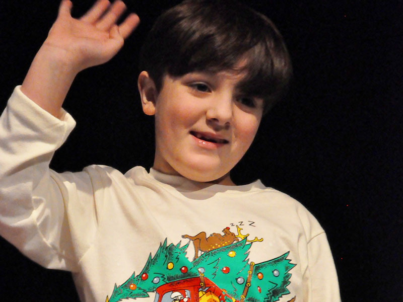 West Fannin Elementary School student Cayden Cantrell waved to his parents before he performed in the school’s White Christmas program.
