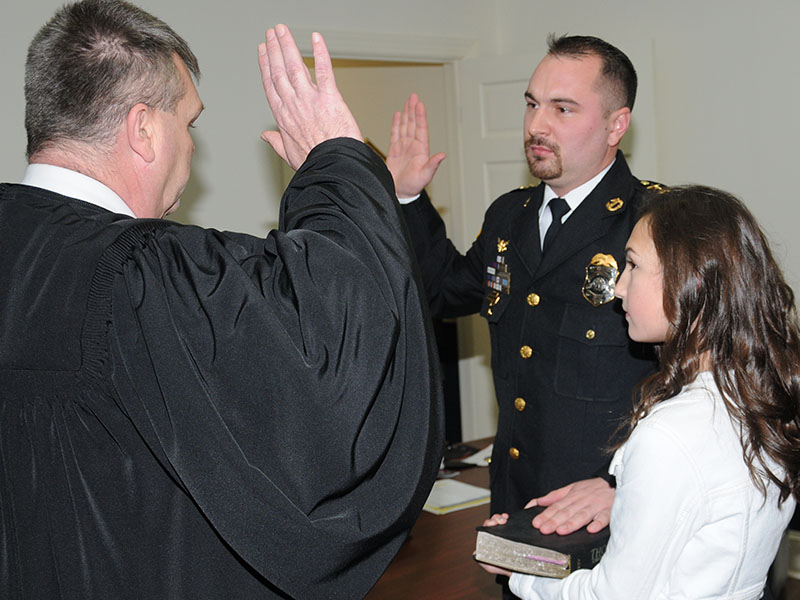Mike Earley, right, was sworn in as McCaysville’s police chief after he was unanimously appointed to the position by the city council at its January 14 meeting. The ceremony was conducted by Fannin County Chief Magistrate Judge Brian Jones as Madison Earley held a Bible.