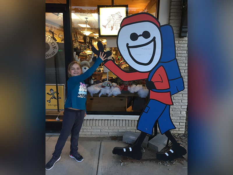 Elohi Law, a fifth grader at West Fannin Elementary, high fives the “Life is Good” guy in downtown Blue Ridge this past January.