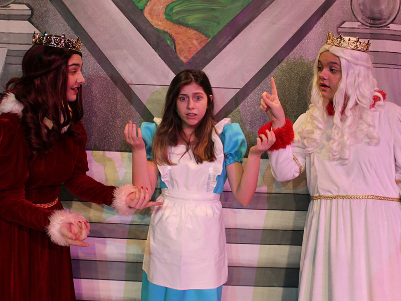 Go down the rabbit hole with the theater’s “Alice in Wonderland.” Here, Alice (Reece Lindstrom, center) stands between the feuding Red Queen (Kennedy Davies) and the White Queen (Kaitlyn Gilreath).