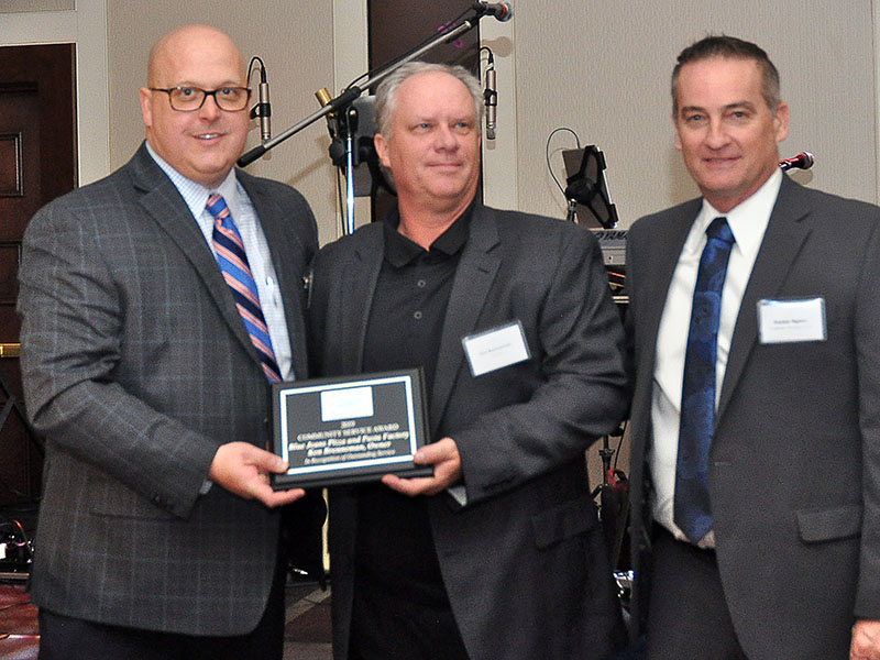 Fannin County Chamber of Commerce Chairman Elect Brandon Holloway, left, and Chairman Frankie Rigdon, right, presented Ken Brenneman with the Community Service Award at the chamber’s 36th Annual Banquet, January 25.