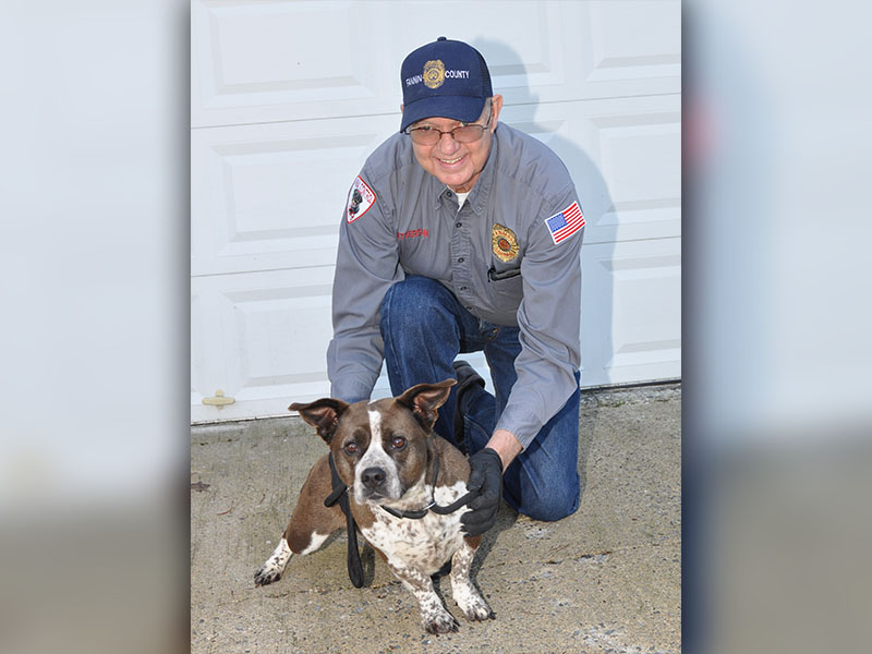 Fannin County Animal Control Officer Pat Patterson kneels next to this super cute Basset Hound mix. The female pup was dropped off at the facility January 13 and will remain there until adopted or transfered to a rescue. She has a short, smooth coat of hot chocolate and milk and boasts adorable stubby legs. View this sweetie pie under Animal Control number 016-20.