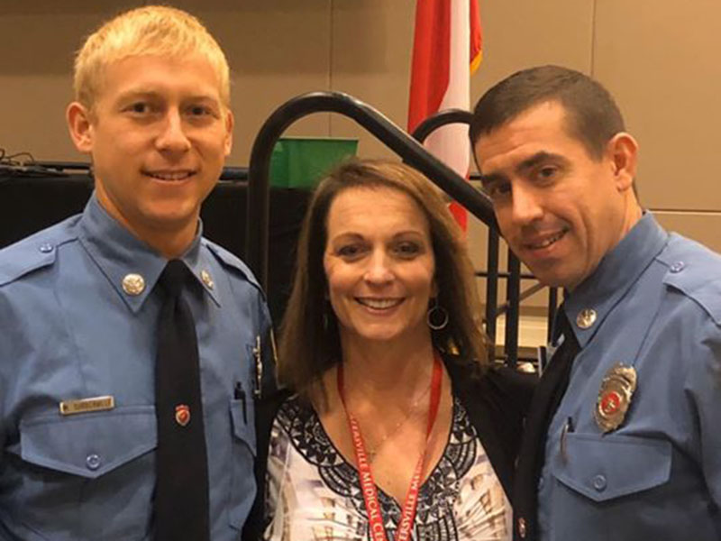 Tina Davis stands with two of the emergency services personnel who responded to Davis’ house when she was shot seven times by her estranged husband. Shown with Davis are, from left, EMT Michael Turberville and paramedic Billy Pflugrad.