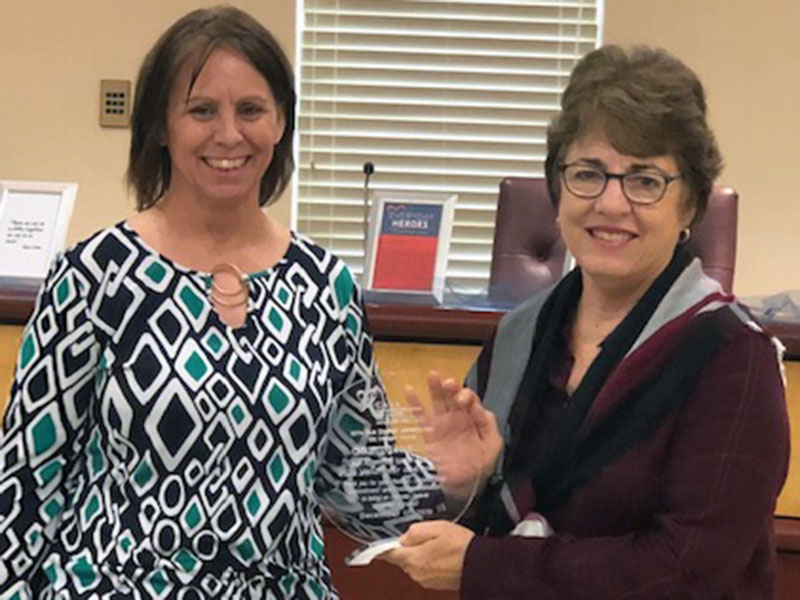 Appalachian CASA Executive Director Melanie Davis, right, presents the 2020 Appalachian CASA Volunteer of the Year award to Chris Martinez. Martinez has dedicated five years to the Appalachian Judicial Circuit as a Court Appointed Special Advocate (CASA).