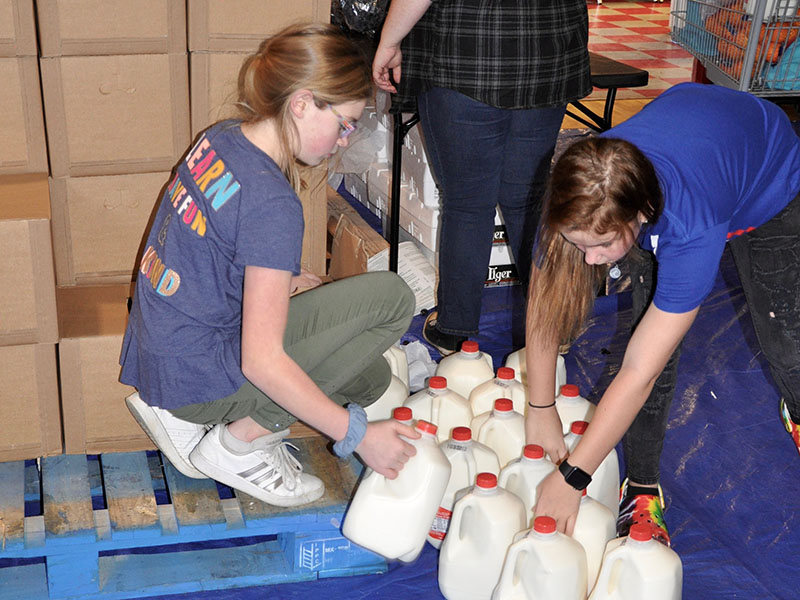 Volunteers grab some whole milk for Copper Basin community members Thursday, January 16.