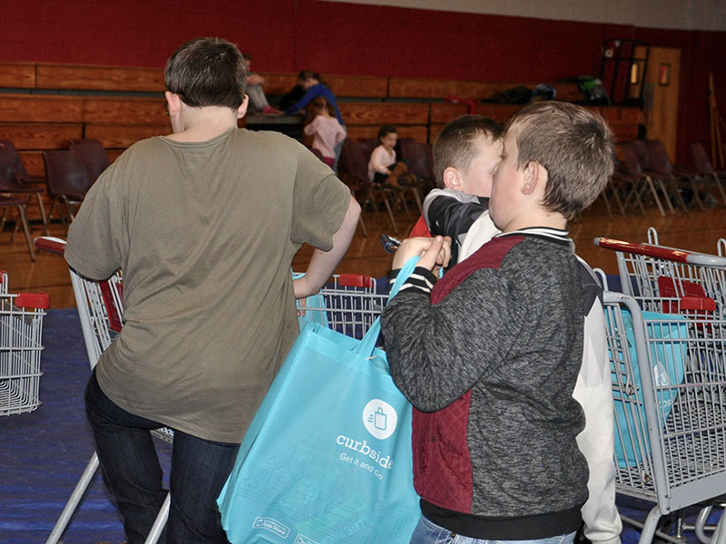 Young volunteers fill buggies and bags full of food for Copper Basin Elementary School’s (CBES) monthly food bank Thursday, January 16. CBES holds a food bank the third Thursday of every month.