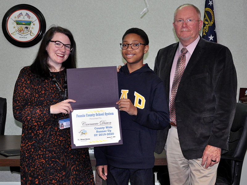 Fannin County Middle School Student Carnaceo Dixon, middle, was this year’s County Wide Spelling Bee runner up. He will serve as the alternate for Winner Kaylee Trotter at the regional competition. With Dixon is Director of Instructional Services and Policy Sarah Welch and Principal Keith Nuckolls.