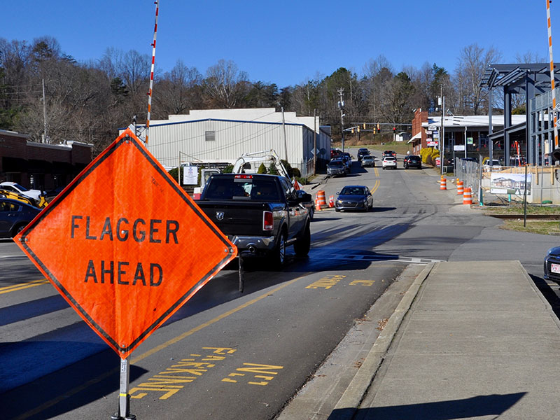 Cars navigate their way around the West Main Street construction that blocked one lane on Mountain Street in Blue Ridge. No flagger was present to direct traffic Tuesday, December 31, despite lane obstructions.