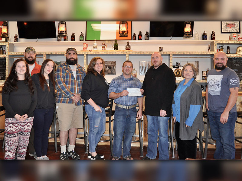 Copperhill Brewery raised $3,000 and River Laurel Gifts & Boutique raised $500 for the Fannin County Family Connection Food Pantry during the holiday season. Shown during the check presentation are, from left, Caroline Allen, Joe Bugg, Mika Bowser, Alan Reis, Pamela Abbott, Food Pantry Manager Greg Gelp, Harrison Abbott, Family Connection Executive Director Sherry Morris and Macho Liberti.