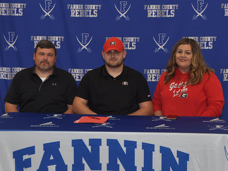 Fannin County Rebel Miles Johnson chose to further his academic and football career Wednesday, February 5, when he signed to become a preferred walk on at the University of Georgia. Pictured are, from left, Earl Johnson, father; Miles Johnson and Leslie Mann, mother.