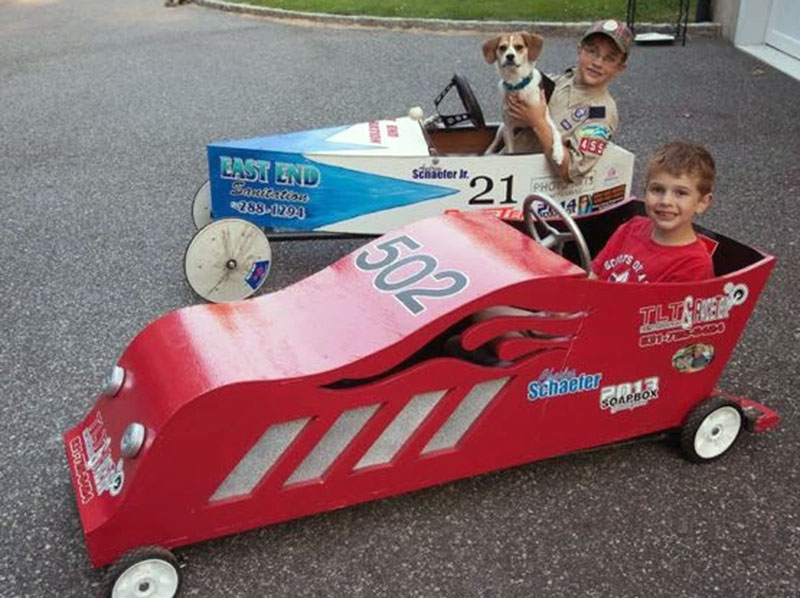 These boys and their best friend, of the canine variety, test out the Blue Ridge Soap Box Derby cars they built for last year’s race. This year’s race is April 25.