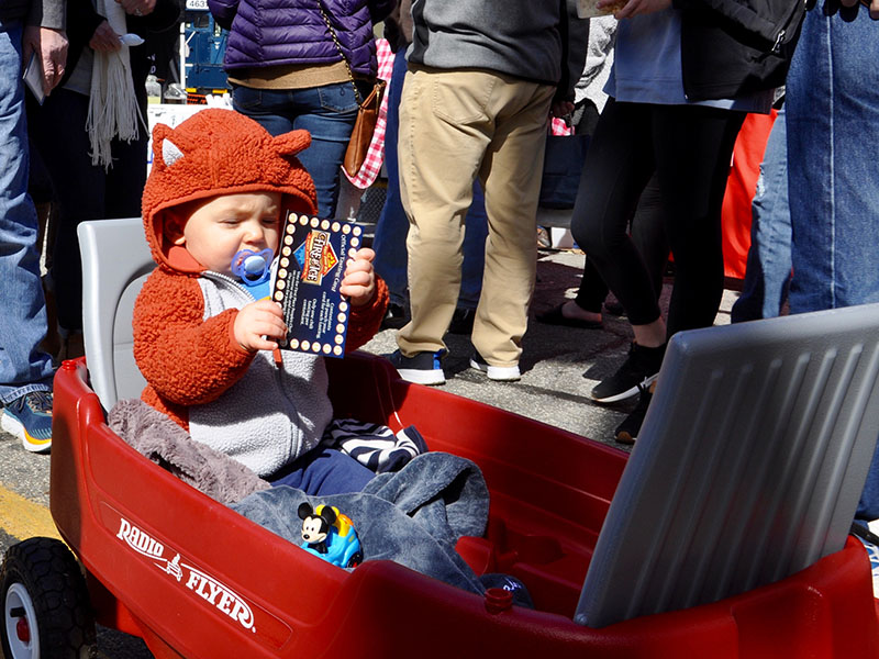 Little Noah inspects his chili card, while being hauled in a red wagon during Blue Ridge’s Fire & Ice Chili Cook-Off and Craft Beer Festival.