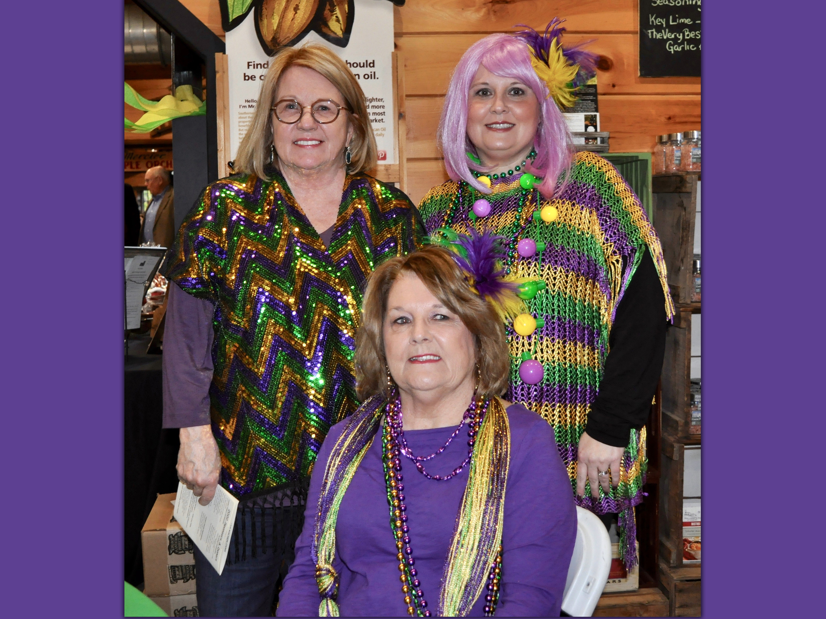 Purple, green and gold outfits were prominately displayed during Snack in a Backpack’s Mardi Gras themed fundraiser, Bringin’ the Blues to Blue Ridge, Saturday, February 22. Shown are, from left, Jeanie Morris, Margie Smith and Stephanie Danuser.