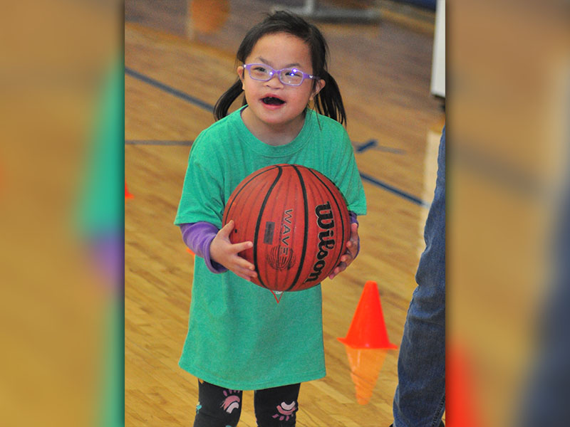Lydia Shamblin smiles as the crowd cheers her on during the dribbling competition at Fannin County Special Olympics basketball competition Friday, January 31.