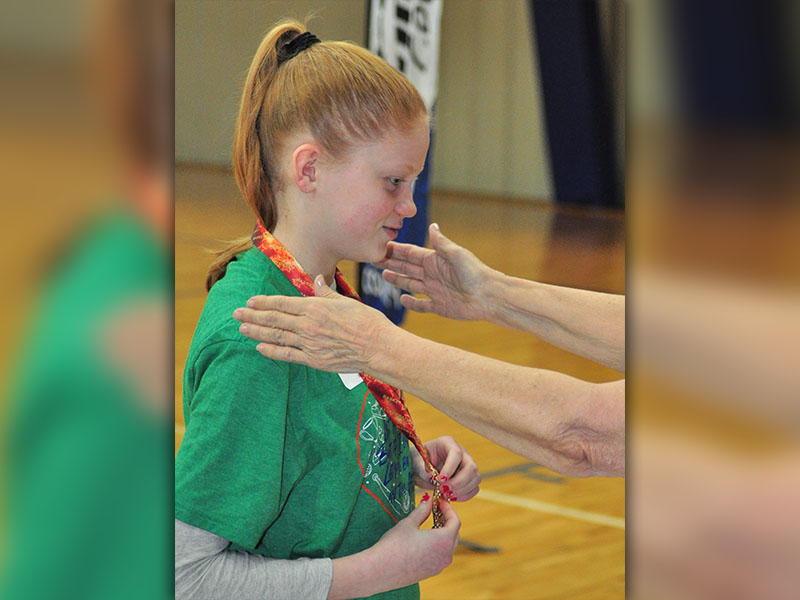 Abbie Dillard smiles as she recieves a first place medal during the Fannin County Special Olympics basketball competition Friday, January 31.
