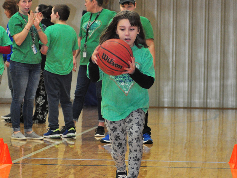 Special Olympics athlete Christina Evans races for the best time during a drill at the Fannin County Special Olympics basketball competition Friday, January 31.